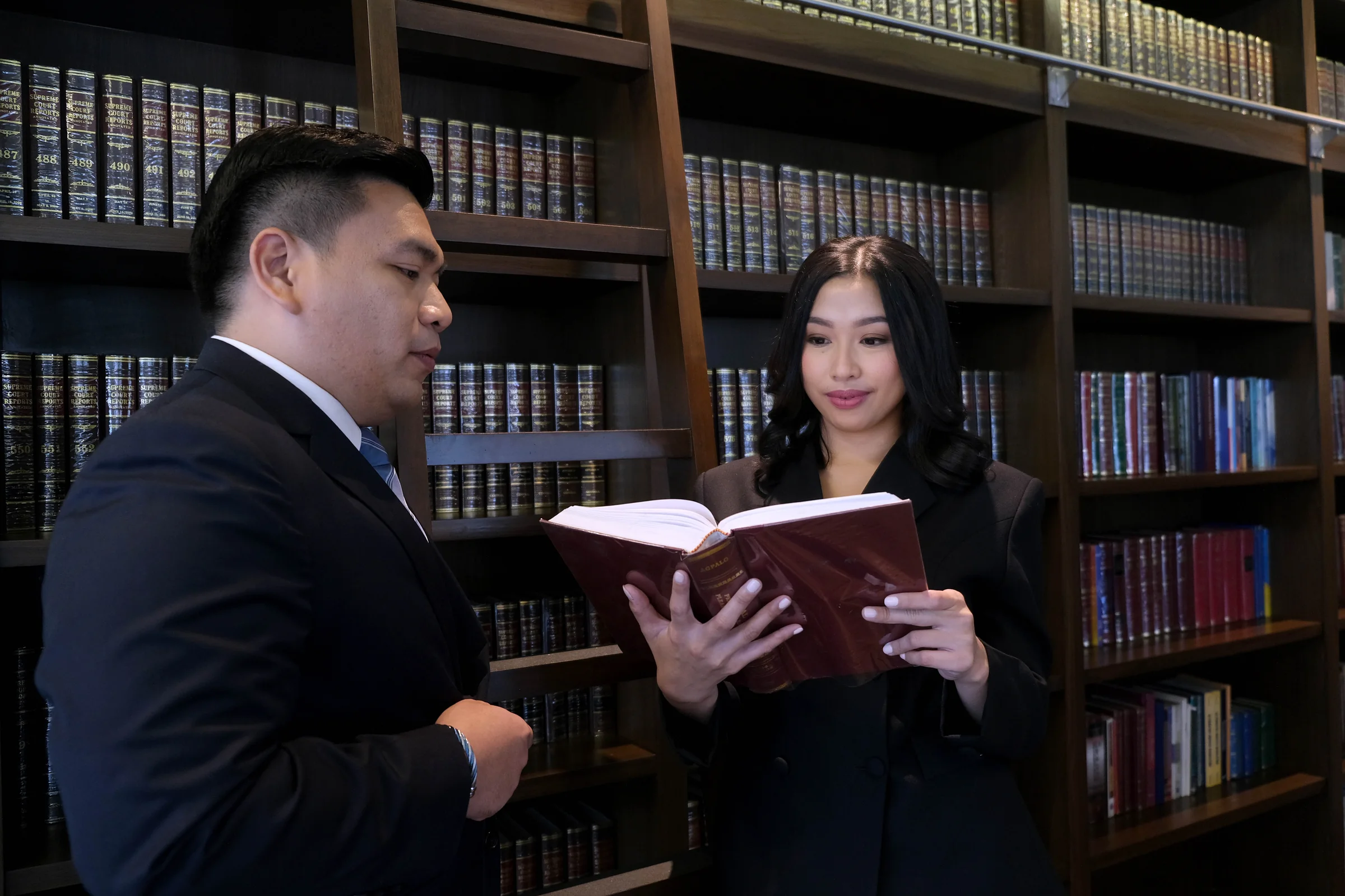 Gaspar Cañeba Franco lawyers reviewing a law book